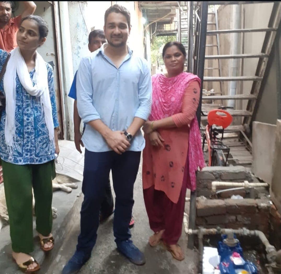 With residents of Indira Gandhi Camp after the pump went in. 3,000 people now have water at their doorstep.